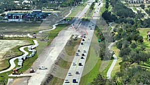 Construction roadworks on american transport infrastructure. Renovation of highway road with moving traffic. Development