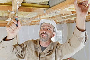 Construction roofer or carpenter working on roof