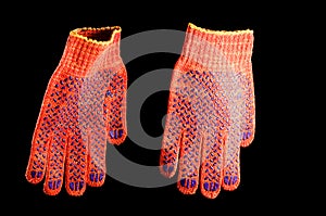 Construction rubberized gloves non-slip orange color on a black background, isolate