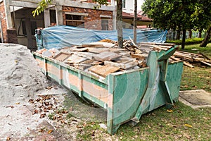 Construction rubbish bin with loads at construction site