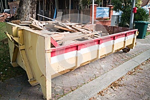 Construction rubbish dumpster with waste at construction site