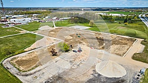 Construction sand piles gravel mound, dirt ground up muddy mess aerial
