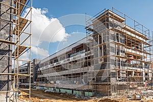 Construction scaffolding built on a new apartment building. new construction under construction