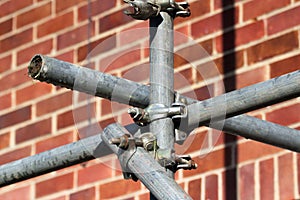 Construction scaffolding with clamps and poles.