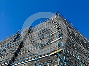 Construction scaffolding of high rise apartment with blue sky