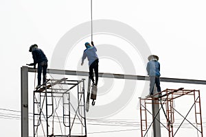 Construction Scaffolding Worker conect the steel beam by gas welding equipment