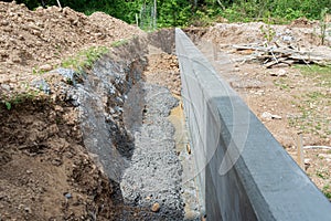 Construction shaft by a concrete wall as a border between two properties