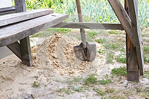 A construction shovel in the sand.