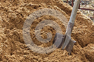 Construction shovel stuck in the sand. break during work