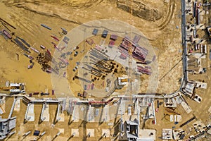 Construction site from above. Aerial view of workplaces in construction equipment, workers with heavy machinery. Industrial top