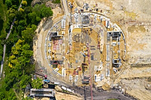 Construction site from above. Aerial view of workplaces in construction equipment, workers with heavy machinery. Industrial top