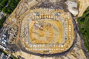 Construction site from above. Aerial view of workplaces in construction equipment, workers with heavy machinery. Industrial top