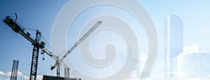 Construction site banner background. Construction industry and business concept. Cranes on a blue background.