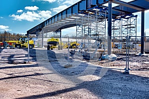 Construction site of a bridge, construction machinery and excavators under a blue sky