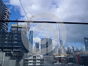 A construction site in the city center of Brisbane, Australia, cranes and new buildings being built.