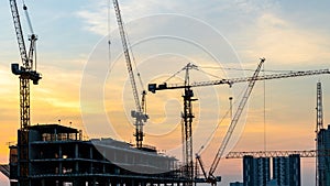 Construction site concept, Silhouette construction crane site at sunset, Structure steel beam build large buildings complex, Crane