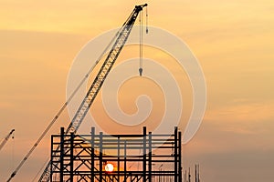 Construction site concept, Silhouette construction crane site at sunset, Structure steel beam build large buildings complex, Crane