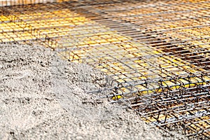 construction site - concrete pouring in slabs. Cement and concrete over reinforced steel