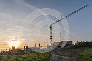 Construction site with construction crane - evening sun