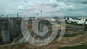 Construction site. Construction of multi-storey buildings. Construction of a city block. Aerial photography.