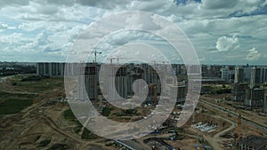 Construction site. Construction of multi-storey buildings. Construction of a city block. Aerial photography.