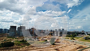 Construction site. Construction of multi-storey buildings. Construction of a city block. Aerial photography