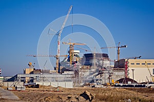 Construction site. Construction of a new nuclear power plant. Cranes are working photo