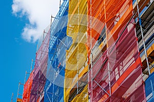 Construction site. Construction, renovation of high-rise residential building, office. Colorful hoarding on construction