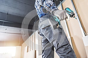 Construction Site Contractor Worker with a Drill Driver