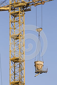 Construction site with crane on blue sky background. Big machinery construction crane tool of building industry for heavy lifting.