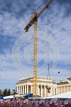 Construction site with crane on blue sky background. Big machinery construction crane tool of building industry for heavy lifting.