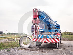 Construction site crane is lifting a led signboard for advertisement