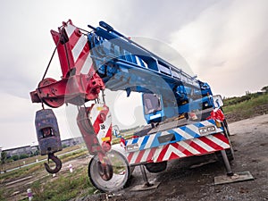 Construction site crane is lifting a led signboard for advertisement