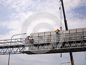 Construction site crane is lifting a led signboard for advertisement