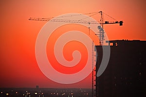 Construction site with crane at sunset
