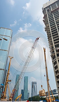 Construction site with crane and tall building background