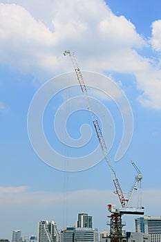 Construction site with cranes against blue sky, Building Construction.