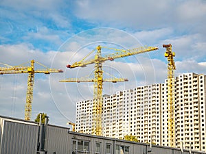 Construction site with cranes against the sky