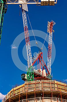 Construction site with cranes with blue sky