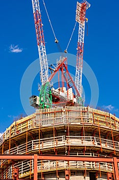 Construction site with cranes with blue sky