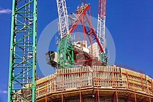 Construction site with cranes with blue sky