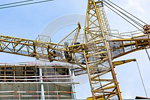 Construction site with cranes and building with blue sky