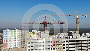 Construction site with cranes and high rise building under