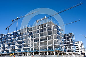 Construction site with cranes for residential buildings