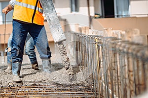 construction site details - building concrete slabs at house construction and pouring cement on reinforcement bars