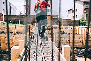 Construction site details - building foundation and pouring concrete on reinforcement bars