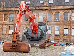 Construction site digger during excavation on building site in city centre