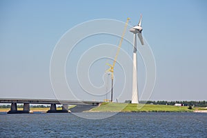 Construction site Dutch windturbine near concrete bridge