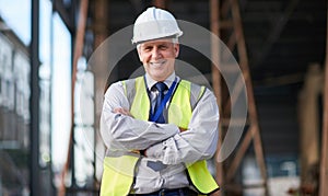 Construction site, engineer and portrait of senior man outdoor for building project management. Happy contractor person