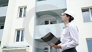 Construction site engineer with tablet checking building technology process.